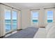 Bedroom with sliding glass doors leading to balcony and ocean view at 1925 S Atlantic Ave # 706, Daytona Beach, FL 32118