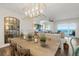 Farmhouse-styled dining area with a long wooden table and ocean view at 1925 S Atlantic Ave # 706, Daytona Beach, FL 32118