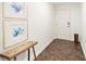 Clean entryway with tile flooring, bench, and coastal art at 1925 S Atlantic Ave # 706, Daytona Beach, FL 32118