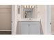 Small bathroom with white vanity and a mirrored medicine cabinet at 2125 Queen Palm Dr, Edgewater, FL 32141