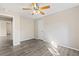 Spacious bedroom with ceiling fan and access to hallway at 2125 Queen Palm Dr, Edgewater, FL 32141