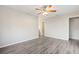 Bright bedroom featuring wood-look floors and a ceiling fan at 2125 Queen Palm Dr, Edgewater, FL 32141