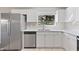 Modern kitchen features stainless steel appliances and white cabinets at 2125 Queen Palm Dr, Edgewater, FL 32141