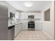 Modern kitchen with white cabinets and appliances at 2125 Queen Palm Dr, Edgewater, FL 32141