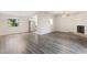 Open living area with wood-look floors and fireplace at 2125 Queen Palm Dr, Edgewater, FL 32141