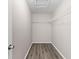 Large walk-in closet with wire shelving and wood-look flooring at 2125 Queen Palm Dr, Edgewater, FL 32141