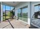 Relaxing screened porch with patio furniture and view of backyard at 24502 Calusa Blvd, Eustis, FL 32736