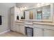 Well-lit bathroom with double sinks, granite counters, custom cabinets, and a large framed mirror at 2815 Sienna View Ter, New Smyrna Beach, FL 32168
