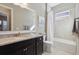 Bathroom with dark vanity, granite countertop and shower/tub combo at 2815 Sienna View Ter, New Smyrna Beach, FL 32168