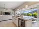 Island kitchen with granite countertops and view of pool at 2815 Sienna View Ter, New Smyrna Beach, FL 32168