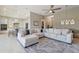 Open-concept living room showcases neutral tones, a large sectional sofa, and seamless flow to the kitchen at 2815 Sienna View Ter, New Smyrna Beach, FL 32168