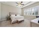 Serene main bedroom with tray ceiling, neutral palette, plantation shutters, and plush carpeting at 2815 Sienna View Ter, New Smyrna Beach, FL 32168