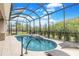 Inviting screened-in pool area with comfortable lounge chairs and lush landscaping provides privacy at 2815 Sienna View Ter, New Smyrna Beach, FL 32168