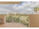This condo's balcony overlooks the expansive green golf course under a cloudy sky at 3 Oceans West Blvd # 4A5, Daytona Beach Shores, FL 32118