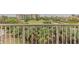 Enjoy the lush green golf course view from the condo's spacious balcony with a metal railing at 3 Oceans West Blvd # 4A5, Daytona Beach Shores, FL 32118