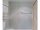 Small bathroom featuring a shower and toilet with patterned wallpaper at 3 Oceans West Blvd # 4A5, Daytona Beach Shores, FL 32118