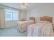Inviting bedroom with twin beds, bright window, and light-colored walls at 3 Oceans West Blvd # 4A5, Daytona Beach Shores, FL 32118
