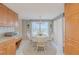 Cozy eat-in kitchen features a white table set and a bright window view at 3 Oceans West Blvd # 4A5, Daytona Beach Shores, FL 32118