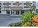 Exterior of condominium building 3 showing landscaped entryway and parking at 3 Oceans West Blvd # 4A5, Daytona Beach Shores, FL 32118