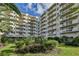 Beautiful condo building with lush landscaping, balconies, and a view of the sky at 3 Oceans West Blvd # 4A5, Daytona Beach Shores, FL 32118