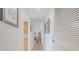 Hallway with views of the kitchen, hardwood floors and pictures on the wall at 3 Oceans West Blvd # 4A5, Daytona Beach Shores, FL 32118