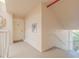 Well-lit hallway with stair access and white door entrance to condo at 3 Oceans West Blvd # 4A5, Daytona Beach Shores, FL 32118