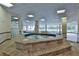 Inviting indoor hot tub area with large windows and tile surround at 3 Oceans West Blvd # 4A5, Daytona Beach Shores, FL 32118