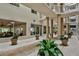 Spacious lobby with potted plants, tile flooring and plenty of natural light at 3 Oceans West Blvd # 4A5, Daytona Beach Shores, FL 32118