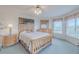 Bright main bedroom featuring natural wood furniture, carpet, and a window view at 3 Oceans West Blvd # 4A5, Daytona Beach Shores, FL 32118