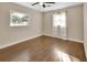Well-lit bedroom featuring hardwood floors and a window with curtains at 3070 Grand Ave, Deland, FL 32720