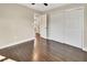 Bedroom with hardwood floors and access to another room at 3070 Grand Ave, Deland, FL 32720