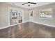 Bedroom with hardwood floors, sliding glass doors, and view to living area at 3070 Grand Ave, Deland, FL 32720