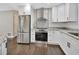 Stainless steel appliances and granite countertops in this updated kitchen at 3070 Grand Ave, Deland, FL 32720