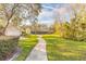 Curving concrete pathway meanders through lush green landscape at 32543 Crystal Breeze Ln, Leesburg, FL 34788
