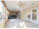 Sunroom featuring tile floors, ceiling fans and access to backyard at 32543 Crystal Breeze Ln, Leesburg, FL 34788