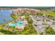 Aerial view of resort-style community with pool, lake, and parking at 3328 Marsili Ave, New Smyrna Beach, FL 32168