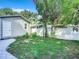 Landscaped backyard with privacy fence and shed at 345 N Clara Ave, Deland, FL 32720