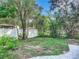 Fenced backyard with grassy area and paver walkway at 345 N Clara Ave, Deland, FL 32720