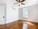 Bedroom with hardwood floors, window, ceiling fan and wall unit at 345 N Clara Ave, Deland, FL 32720