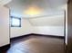 Bright attic bedroom with hardwood floors and arched windows at 345 N Clara Ave, Deland, FL 32720