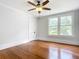 Spacious bedroom featuring hardwood floors, large windows, and a ceiling fan at 345 N Clara Ave, Deland, FL 32720