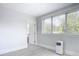 Bright bedroom with large window and gray flooring at 345 N Clara Ave, Deland, FL 32720