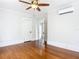 Bedroom with hardwood floors, ceiling fan, and access to another room at 345 N Clara Ave, Deland, FL 32720