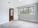 Spacious bedroom with large window and gray flooring at 345 N Clara Ave, Deland, FL 32720