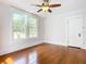 Hardwood floors, ceiling fan and two windows offering natural light at 345 N Clara Ave, Deland, FL 32720