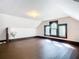 Simple attic bedroom with hardwood floors and single window at 345 N Clara Ave, Deland, FL 32720