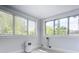 Bright bedroom with large windows and gray flooring at 345 N Clara Ave, Deland, FL 32720