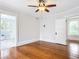 Charming bedroom with hardwood floors, ceiling fan and access to bathroom at 345 N Clara Ave, Deland, FL 32720