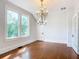 Sunlit dining room with hardwood floors and a beautiful chandelier at 345 N Clara Ave, Deland, FL 32720