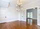 Bright dining room with hardwood floors, chandelier and access to other rooms at 345 N Clara Ave, Deland, FL 32720